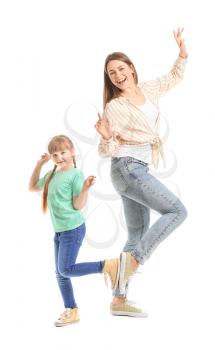 Happy mother and her little daughter dancing against white background�