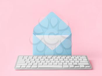 Envelope and computer keyboard on color background. Paper mail vs. e-mail�