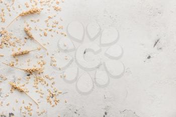 Scattered raw oatmeal on light background�