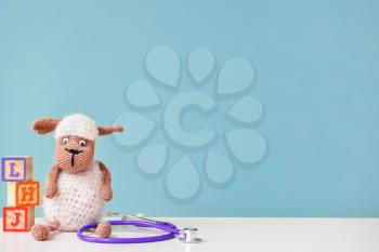 Stethoscope and baby toy on table�