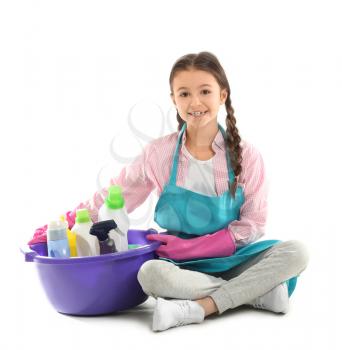 Little housewife with cleaning supplies on white background�