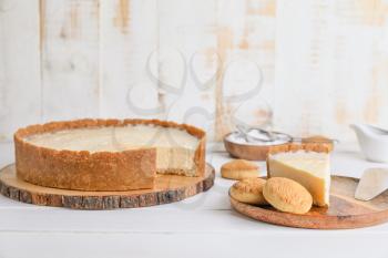 Sweet tasty cheesecake and cookies on table�