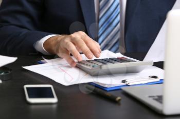 Male accountant working in office, closeup�