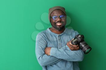 African-American photographer on color background�