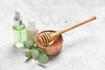 Spa items and honey on light background�