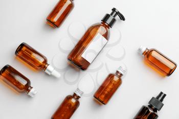 Different cosmetic products in bottles on white background�