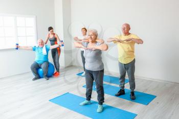 Elderly people exercising in gym�