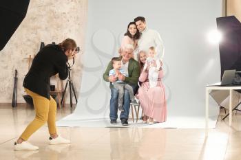 Photographer working with family in studio�