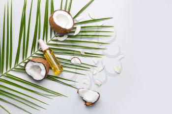 Composition with coconut and oil on light background�