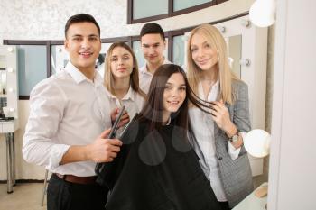 Young people with professional hairdresser and model during courses in salon�