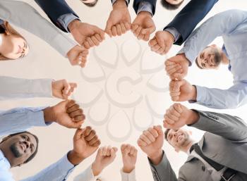 Group of business people putting hands together in office, bottom view. Unity concept�