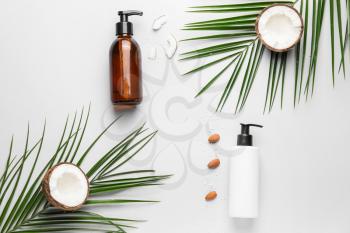Composition with shampoo, almond and coconut on white background�