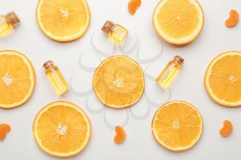 Composition with citrus essential oils on white background�