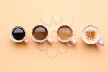 Cups of different coffee on color background�