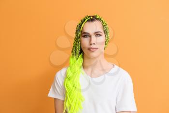 Portrait of young transgender woman on color background�