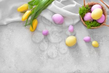 Basket with beautiful Easter eggs on light background�