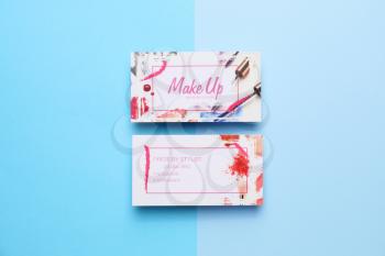 Business cards of makeup artist on color background�