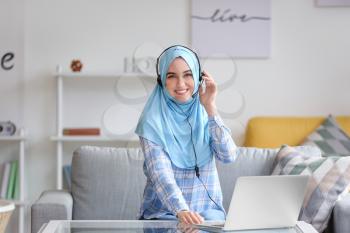 Muslim technical support agent working at home�