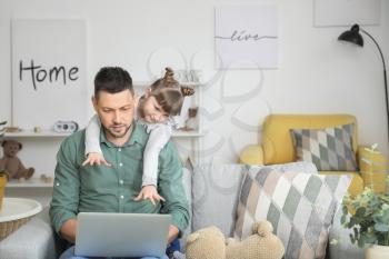 Working father with naughty little daughter at home�
