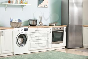 Interior of kitchen with modern washing machine�