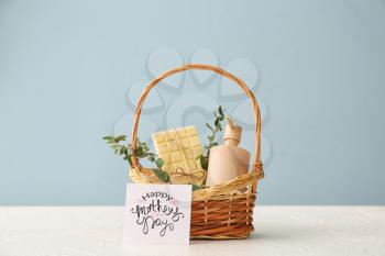 Basket with gifts for Mother's Day on table�