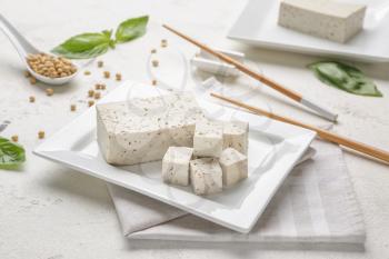 Plate with tasty tofu cheese on table�