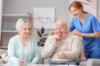 Elderly people suffering from mental disability and caregiver in nursing home�