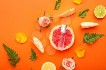 Beautiful composition with perfume bottle on color background�