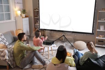 Young friends watching movie at home�