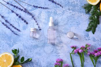 Bottles with essential oils on color background�