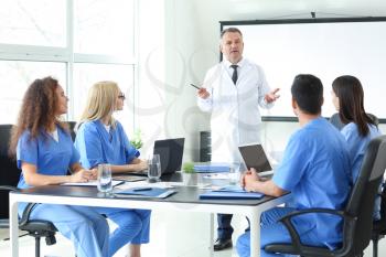 Male lecturer teaching medical students in university�