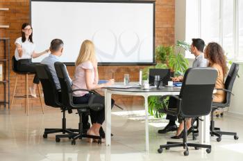 Businesswoman giving presentation during meeting in office�