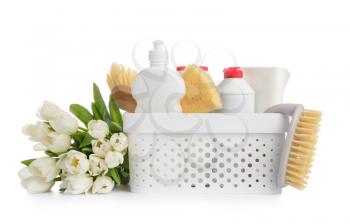 Set of cleaning supplies and spring flowers on white background�