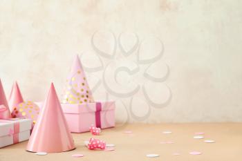 Party hats and gift boxes on light background�