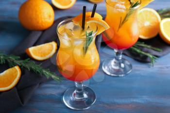 Fresh summer cocktail in glasses on color wooden table�