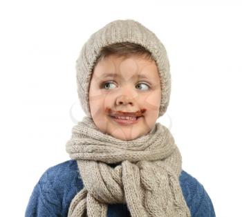 Funny little boy with chocolate on face against white background�