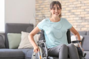 Young woman in wheelchair at home�