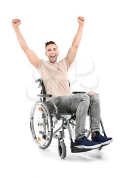 Happy young man sitting in wheelchair on white background�