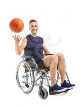 Young basketball player sitting in wheelchair on white background�
