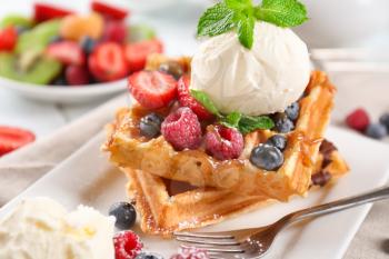 Delicious waffles with berries and ice cream on plate�