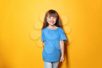 Little girl in t-shirt on color background�