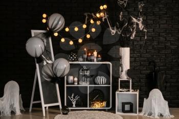 Creative decorations for Halloween party near dark brick wall�