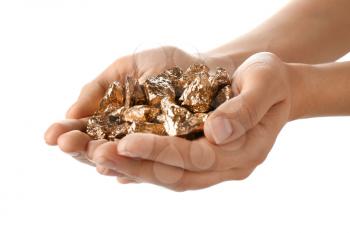 Female hands with gold nuggets on white background�