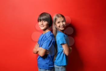 Boy and girl in t-shirts on color background�