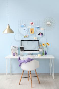 Modern workplace with computer in room�