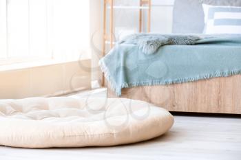 Comfortable pet bed on floor in bedroom�