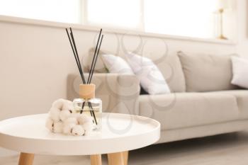 Reed diffuser on table in living room�