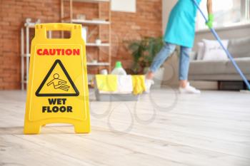 Caution sign with text WET FLOOR in room�