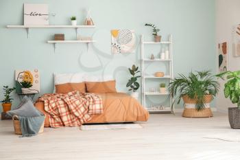 Stylish interior of bedroom with houseplants�
