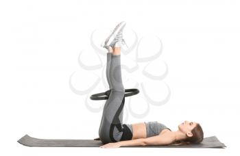 Sporty young woman training against white background�